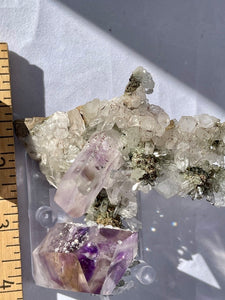 Goboboseb Mountains. Erongo Region, Namibia.  Weight: 180.5 grams  Dimensions: L 5 x W 4 inches x 2.75 inches  So much is going on with this piece. Some notable features include its the insanely gemmy termination thats coated in analcime or the crazy matrix with chlorite terminations. Either way this is definitely one of a kind. 