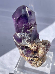 Goboboseb Mountains. Erongo Region, Namibia.  Weight: 180.5 grams  Dimensions: L 5 x W 4 inches x 2.75 inches  Holy smokes this is such an insane piece. Pockets of chalcedony adorn this gorgeous Amethyst point. This baby glows bright green under short wave. Theres pieces that come along once in a lifetime and we consider this to be one of them. Custom stand is included.